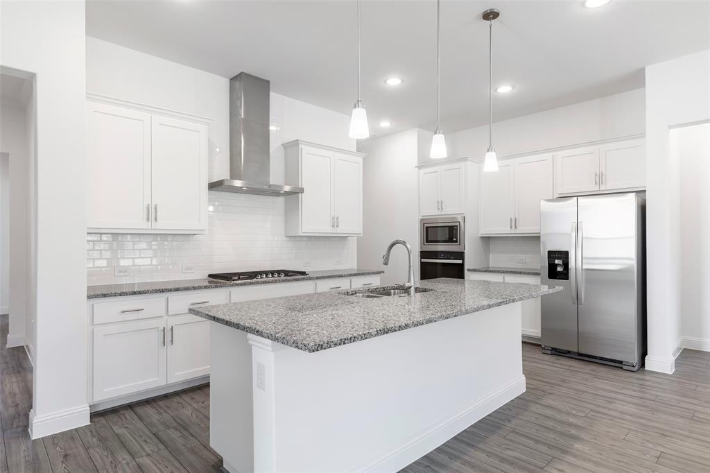 3207 Malcolm Road Melissa, TX 75454 - Photo 9 of 40 a kitchen with stainless steel appliances granite countertop a sink stove and refrigerator