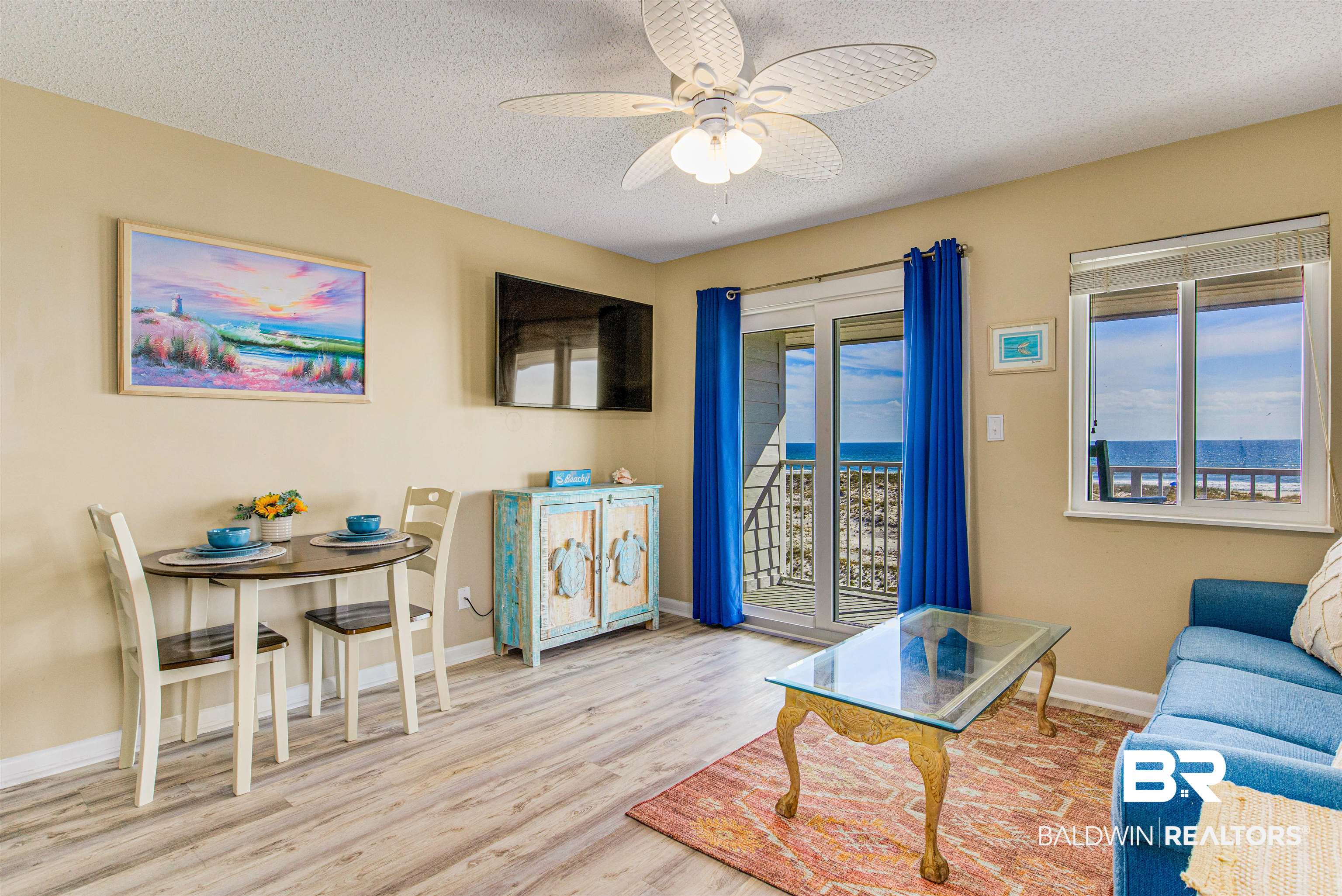 400 Plantation Road, Unit 1303 Gulf Shores, AL 36542 - Photo 5 of 24 Combined living/dining room featuring Gulf front water view, ceiling fan, vinyl flooring & new doors/windows