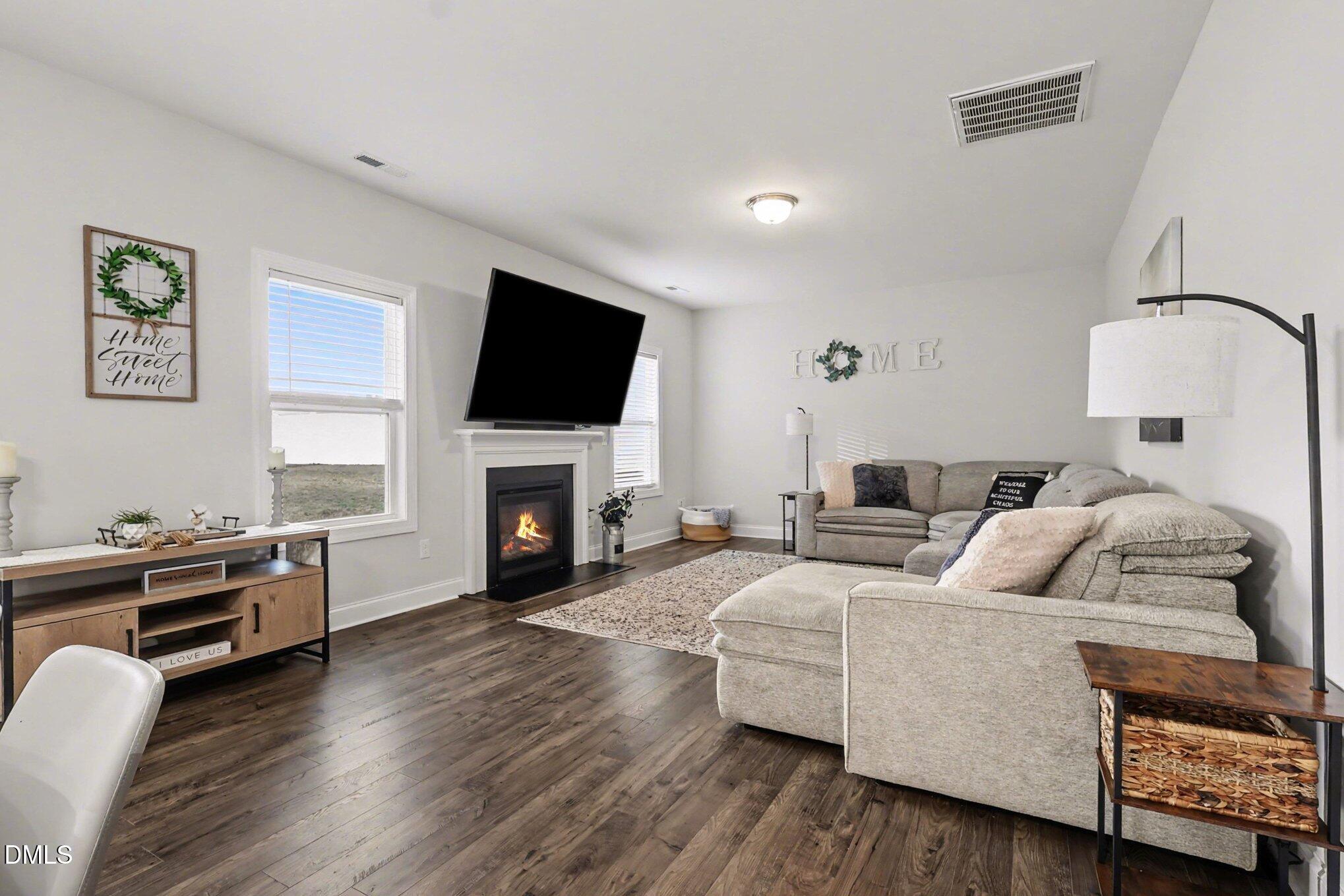 190 Stephens Timberline View Clayton, NC 27520 - Photo 11 of 42 a living room with furniture fireplace and flat screen tv