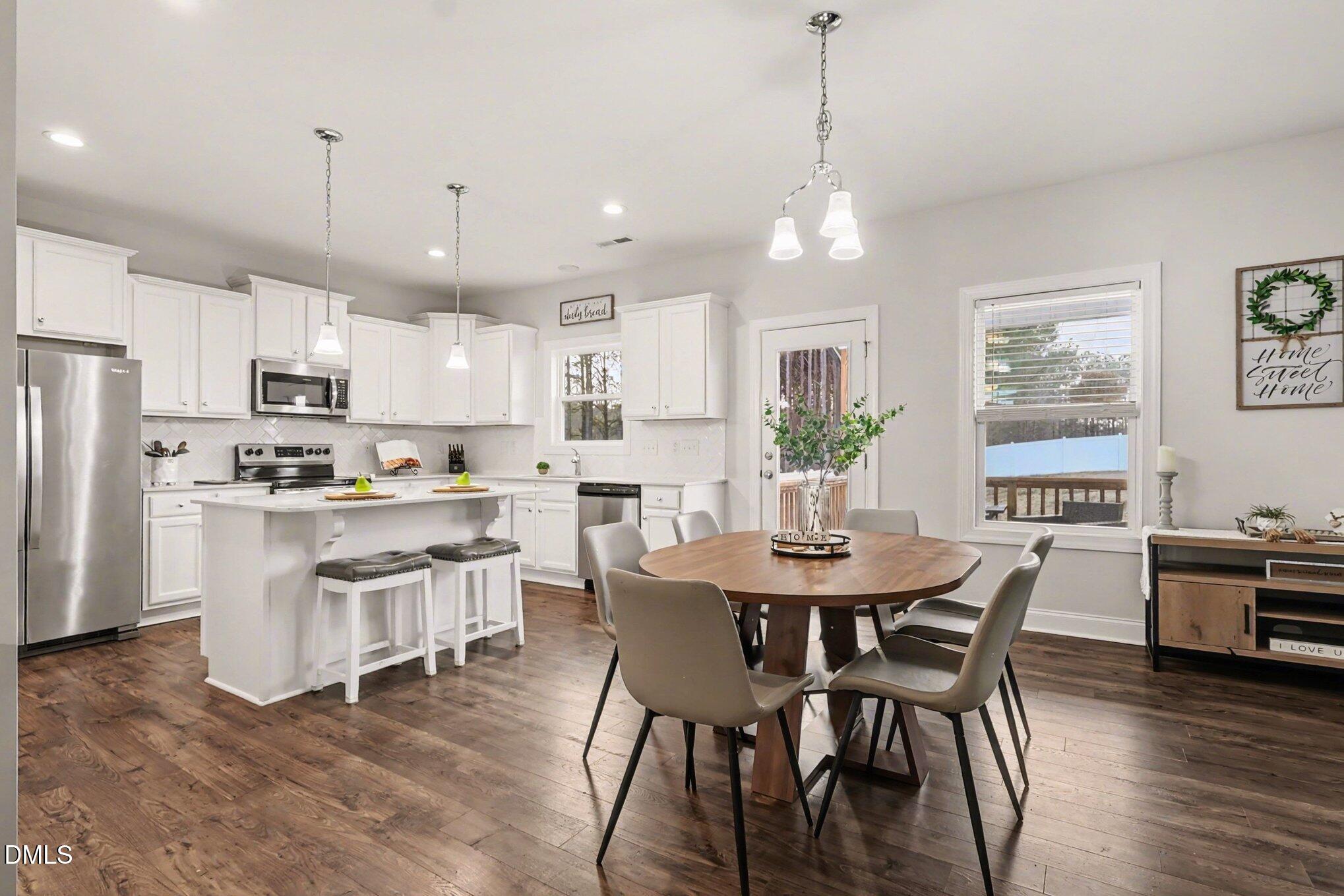 190 Stephens Timberline View Clayton, NC 27520 - Photo 15 of 42 a view of kitchen with refrigerator dining table and chairs