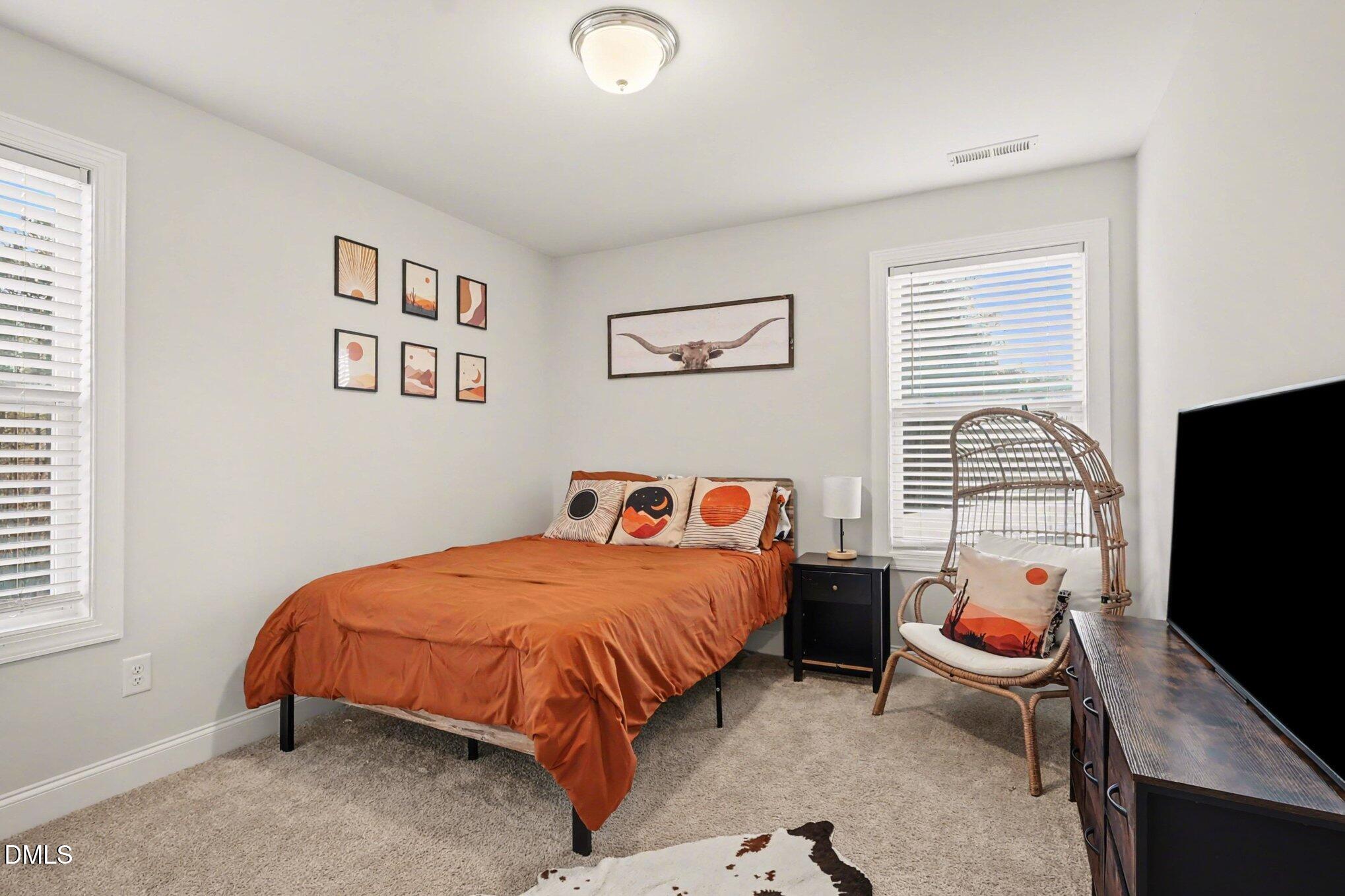 190 Stephens Timberline View Clayton, NC 27520 - Photo 27 of 42 a bedroom with a bed and a flat screen tv