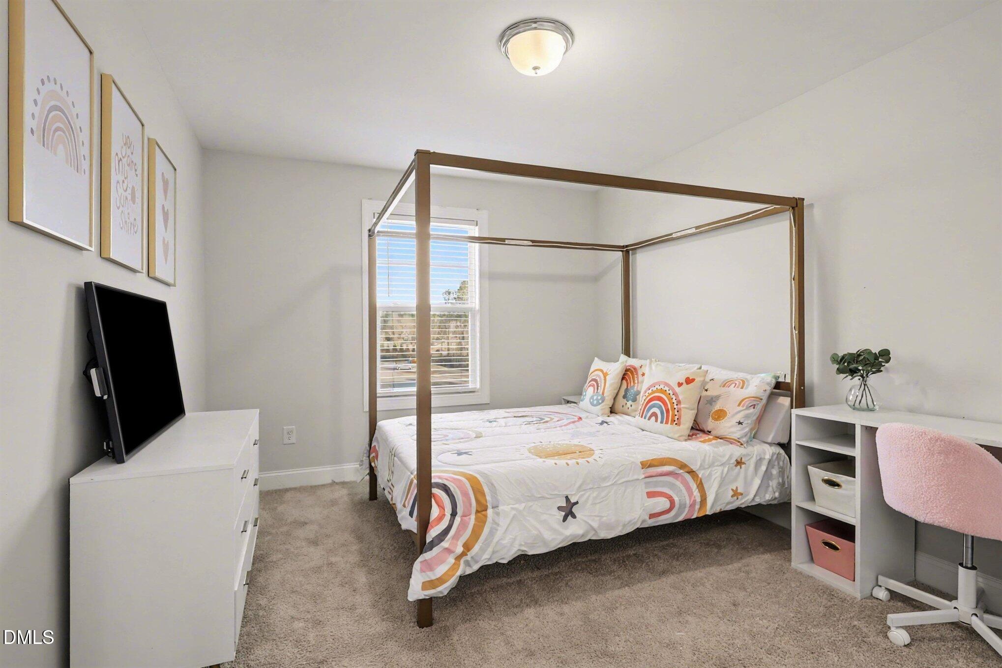 190 Stephens Timberline View Clayton, NC 27520 - Photo 29 of 42 a bedroom with a bed and a flat screen tv