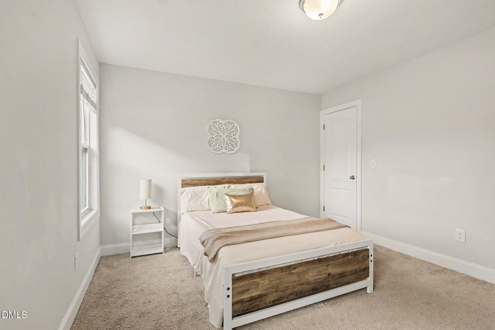 190 Stephens Timberline View Clayton, NC 27520 - Photo 32 of 42 a bedroom with a bed and a lamp on the dresser