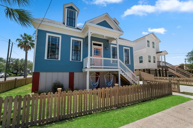 a view of a house with a yard and deck