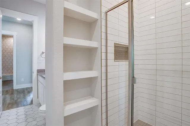 a bathroom with a glass shower door