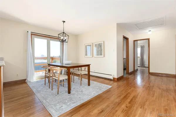 a view of a dining room with furniture window and wooden floor