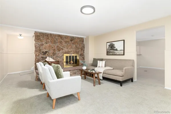 a living room with furniture and a fireplace