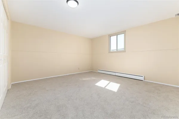 an empty room with a empty space and window