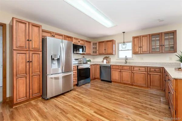 a kitchen with stainless steel appliances granite countertop a refrigerator sink and cabinets