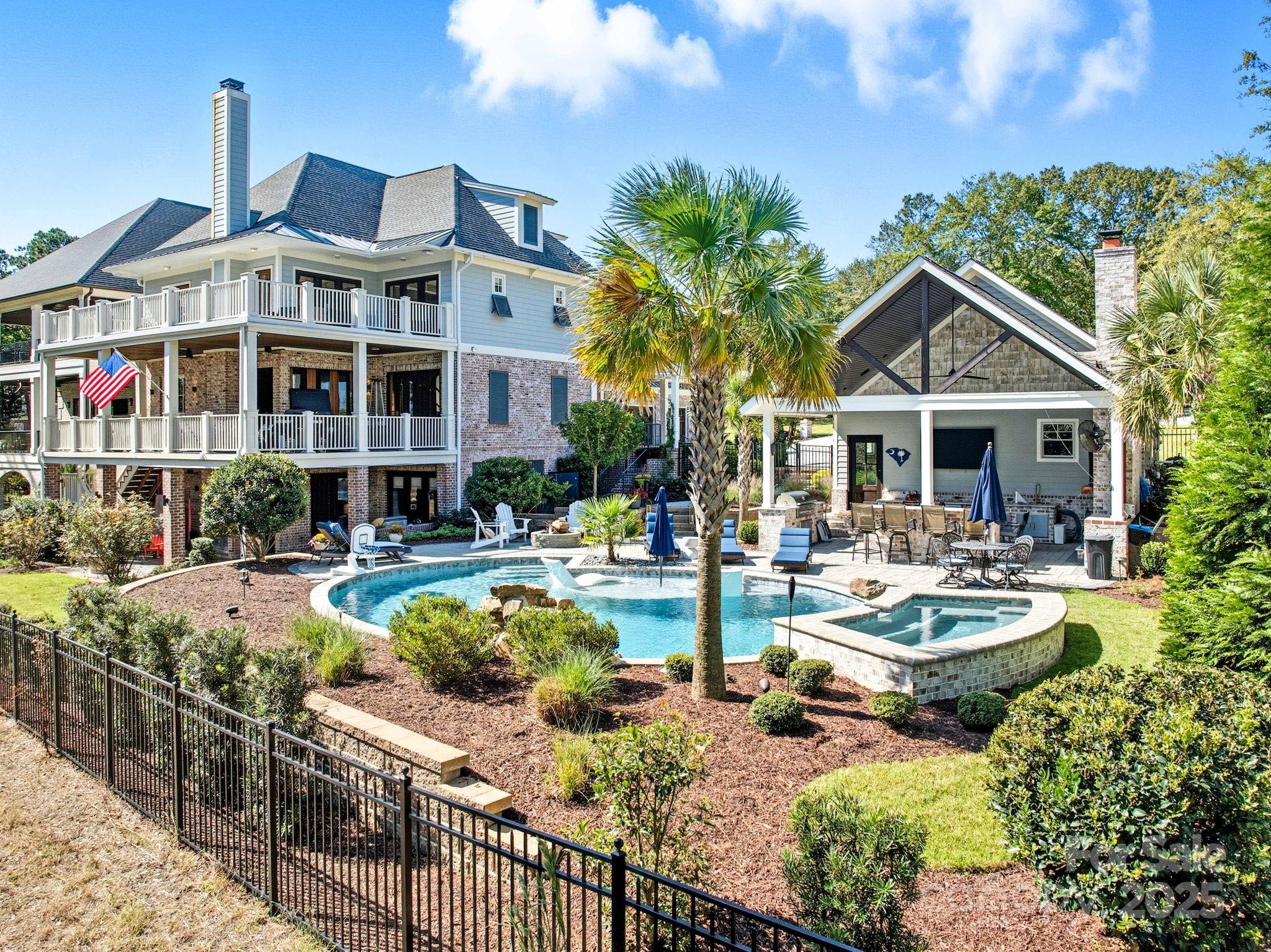 a front view of a house with swimming pool and patio
