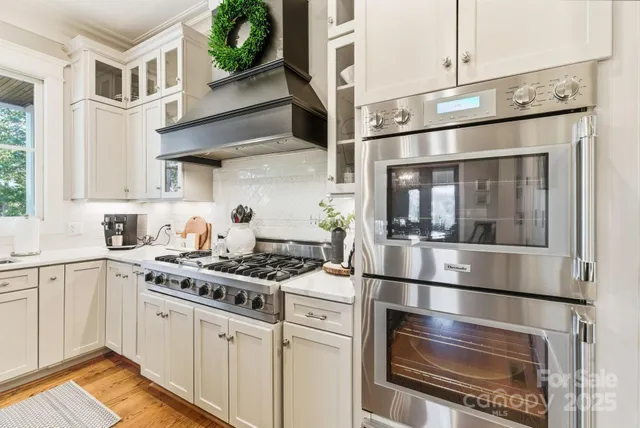 a kitchen with a sink stove and wooden cabinets