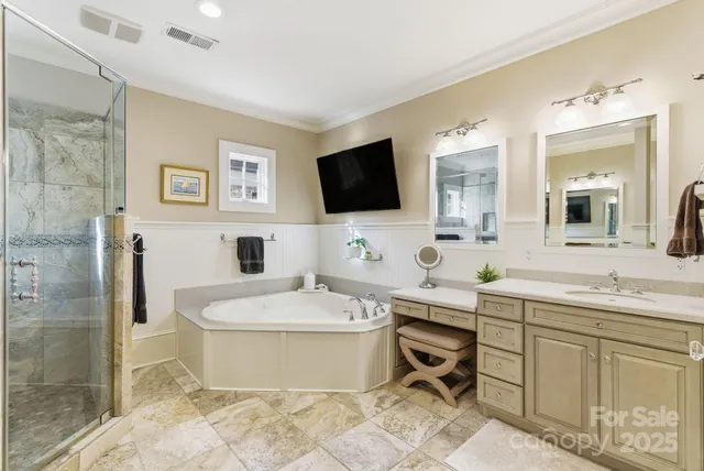 a bathroom with a tub sink and mirror