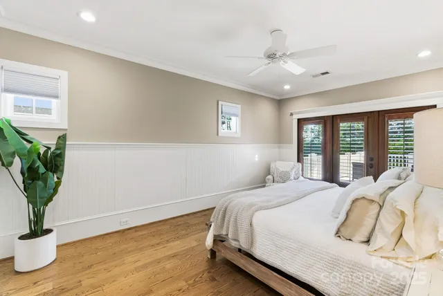 a bathroom with a granite countertop toilet sink mirror and vanity
