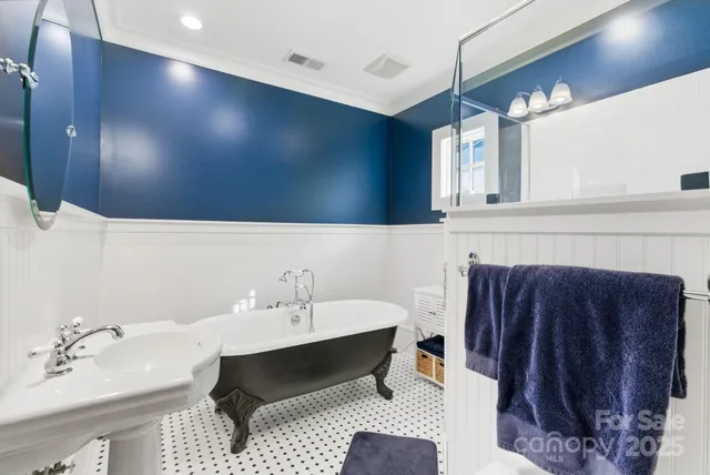 a utility room with stainless steel appliances granite countertop a sink stove and cabinets