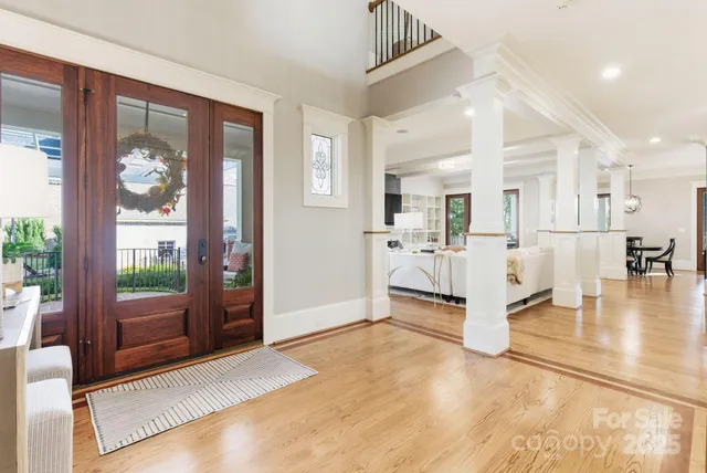 a view of a livingroom with furniture wooden floor and a chandelier