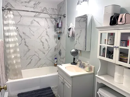 a bathroom with a sink toilet and shower
