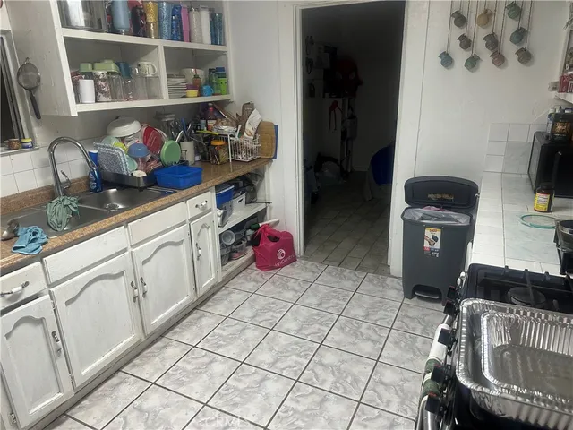 a kitchen with stainless steel appliances granite countertop a refrigerator and a stove