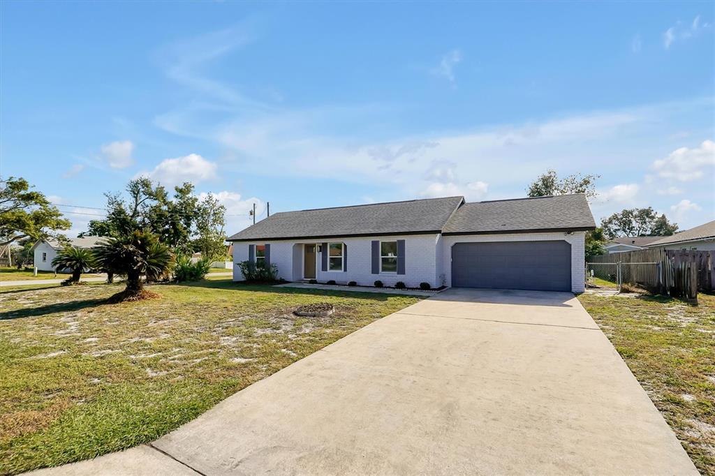 a front view of a house with yard patio and fire pit