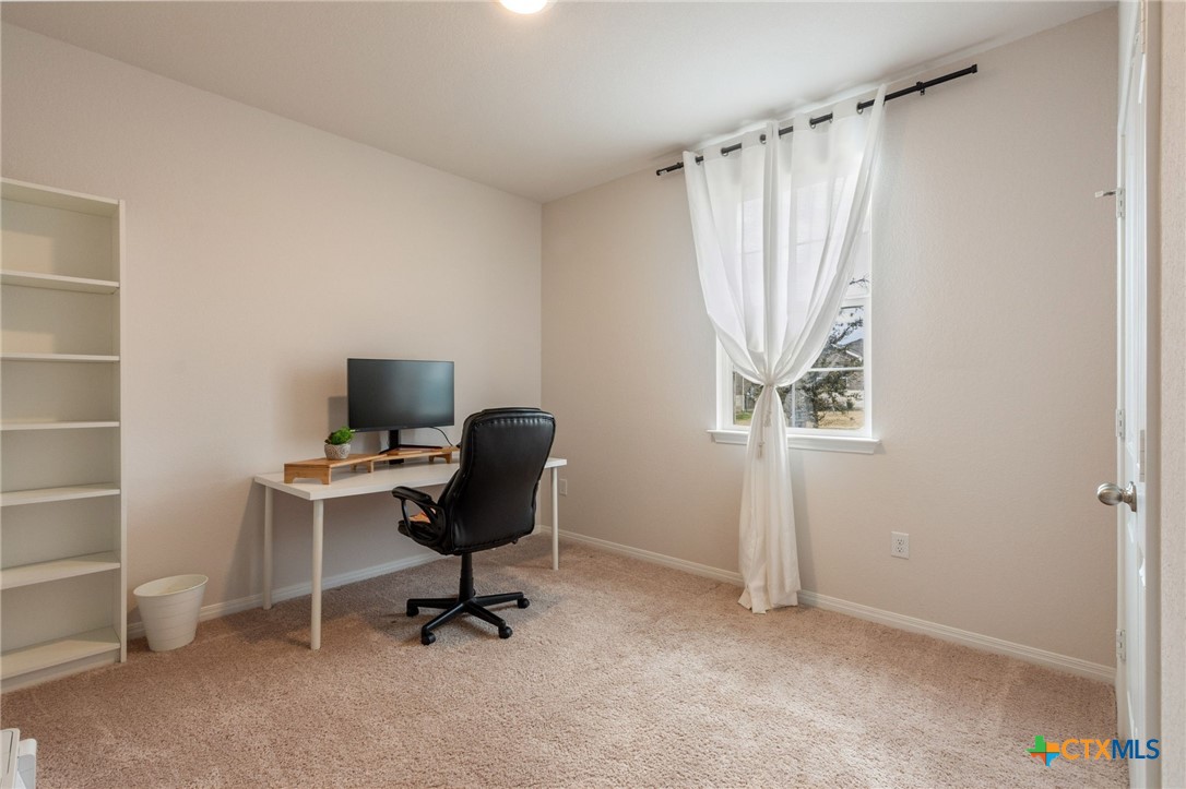 205 Charles Trail Georgetown, TX 78626 - Photo 15 of 38 a view of a workspace with furniture and a window