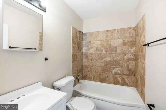 a bathroom with a toilet and a bathtub