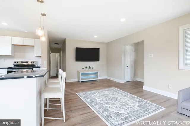 a living room with a flat screen tv and a rug