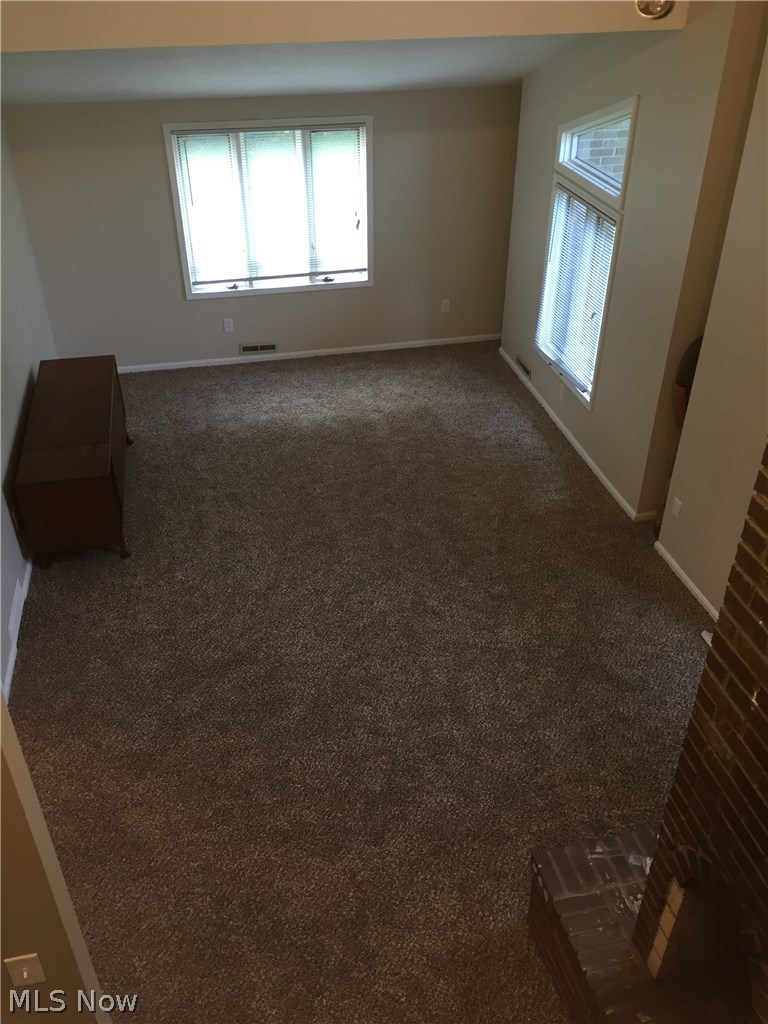 4620 Fenn Road Medina, OH 44256 - Photo 17 of 20 Upstairs landing view of beautiful vaulted living room with new carpet and double sided fireplace