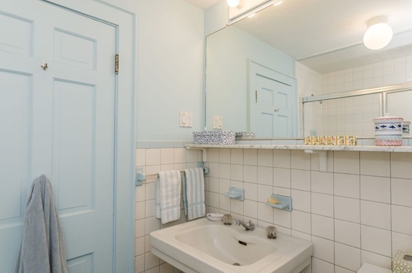 29 Lowell Road Brookline, MA 02445 - Photo 16 of 19 a bathroom with a sink a toilet and mirror