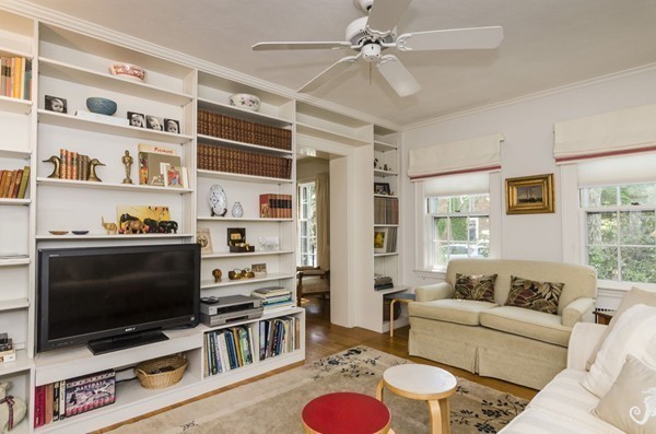 29 Lowell Road Brookline, MA 02445 - Photo 7 of 19 a living room with furniture a flat screen tv and a bookshelf