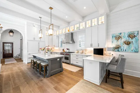 a view of a hallway with wooden floor and entryway