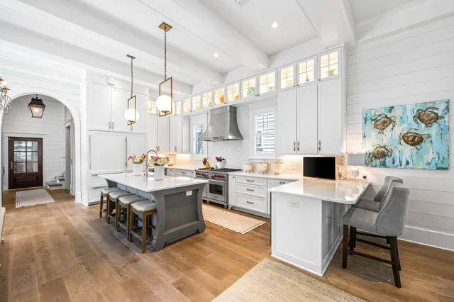 a view of a hallway with wooden floor and entryway