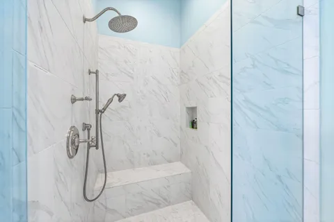 a bedroom with a large bed and a chandelier