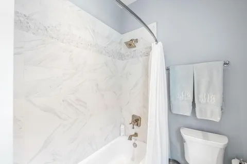 a front view of a house with basket ball court and outdoor seating