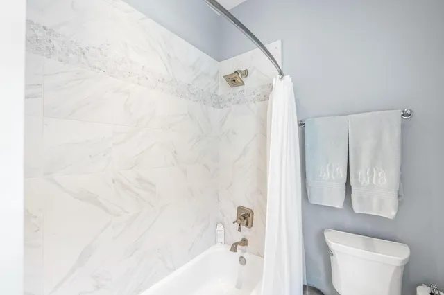 a front view of a house with basket ball court and outdoor seating