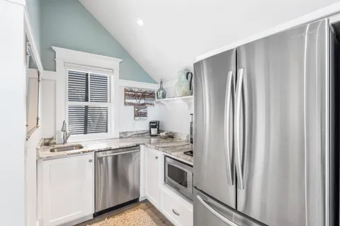 a view of a house with a yard and plants