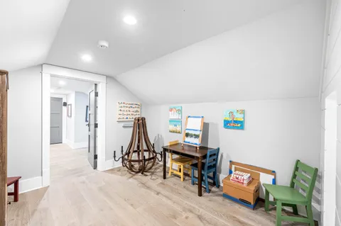 an aerial view of residential houses with outdoor space and trees