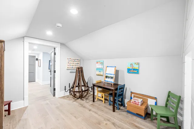 an aerial view of residential houses with outdoor space and trees