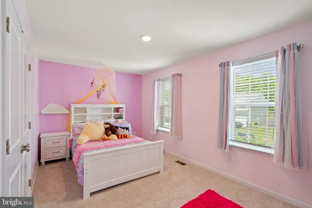 a bed room with a bed and a window