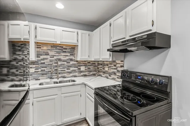 a kitchen with stainless steel appliances and white cabinets