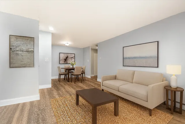 a living room with furniture and wooden floor