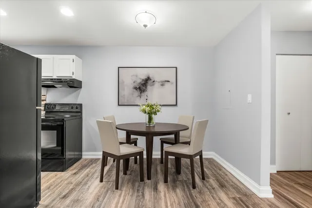 a dining room with furniture and wooden floor