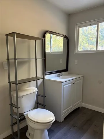 a bathroom with a toilet a sink and a mirror