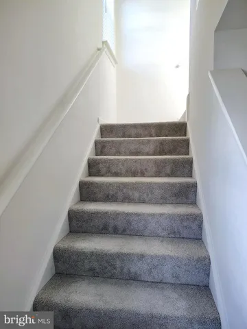 a view of staircase with white walls