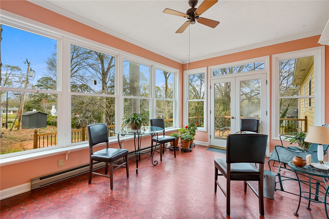 401 Berkshire Hill Anderson, SC 29621 - Photo 12 of 39 This bright sunroom features expansive windows and tiled flooring, perfect for enjoying natural light and outdoor views.
