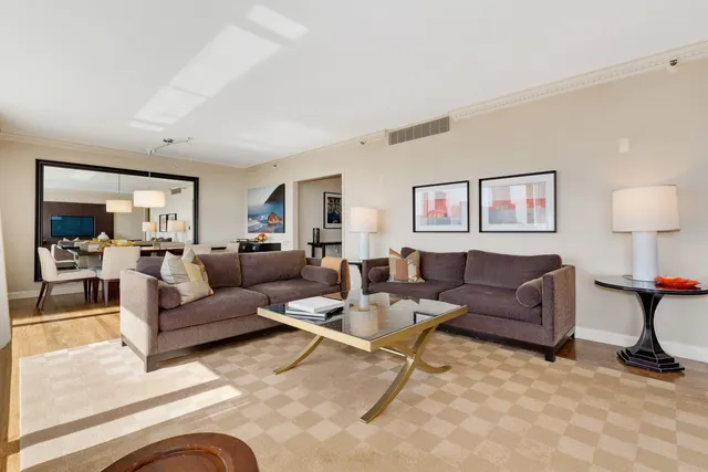 a living room with furniture and a lamp