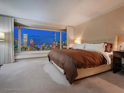 a spacious bedroom with a bed and window