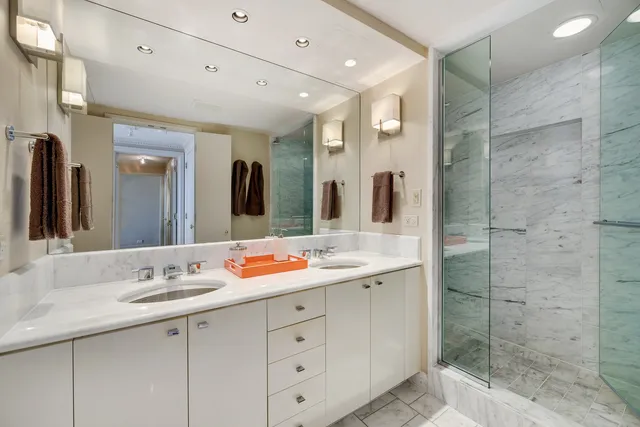 a bathroom with a double vanity sink mirror and double