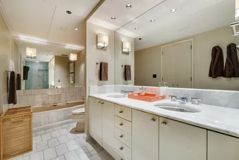 a bathroom with a double vanity sink and a mirror