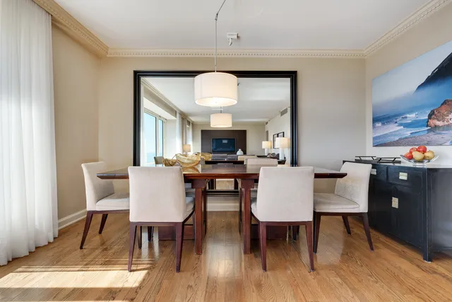 a view of a dining room with furniture and wooden floor