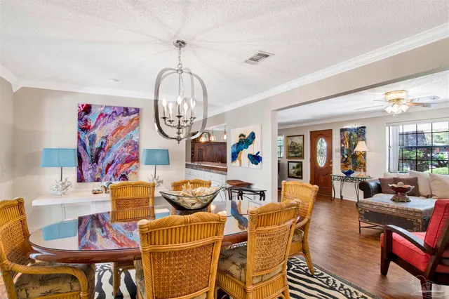 a living room with furniture a rug and a chandelier
