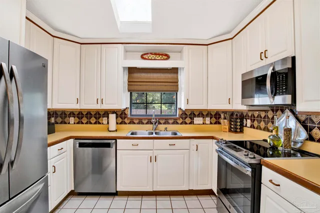 a kitchen with stainless steel appliances a stove sink and cabinets